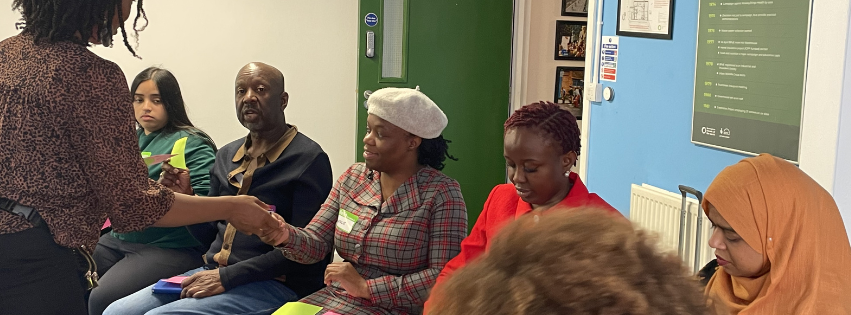 A group of participants from the Amplifying Voices programme gathered together during a workshop session—sharing stories, reflecting on their journeys, and building connections grounded in community and care.